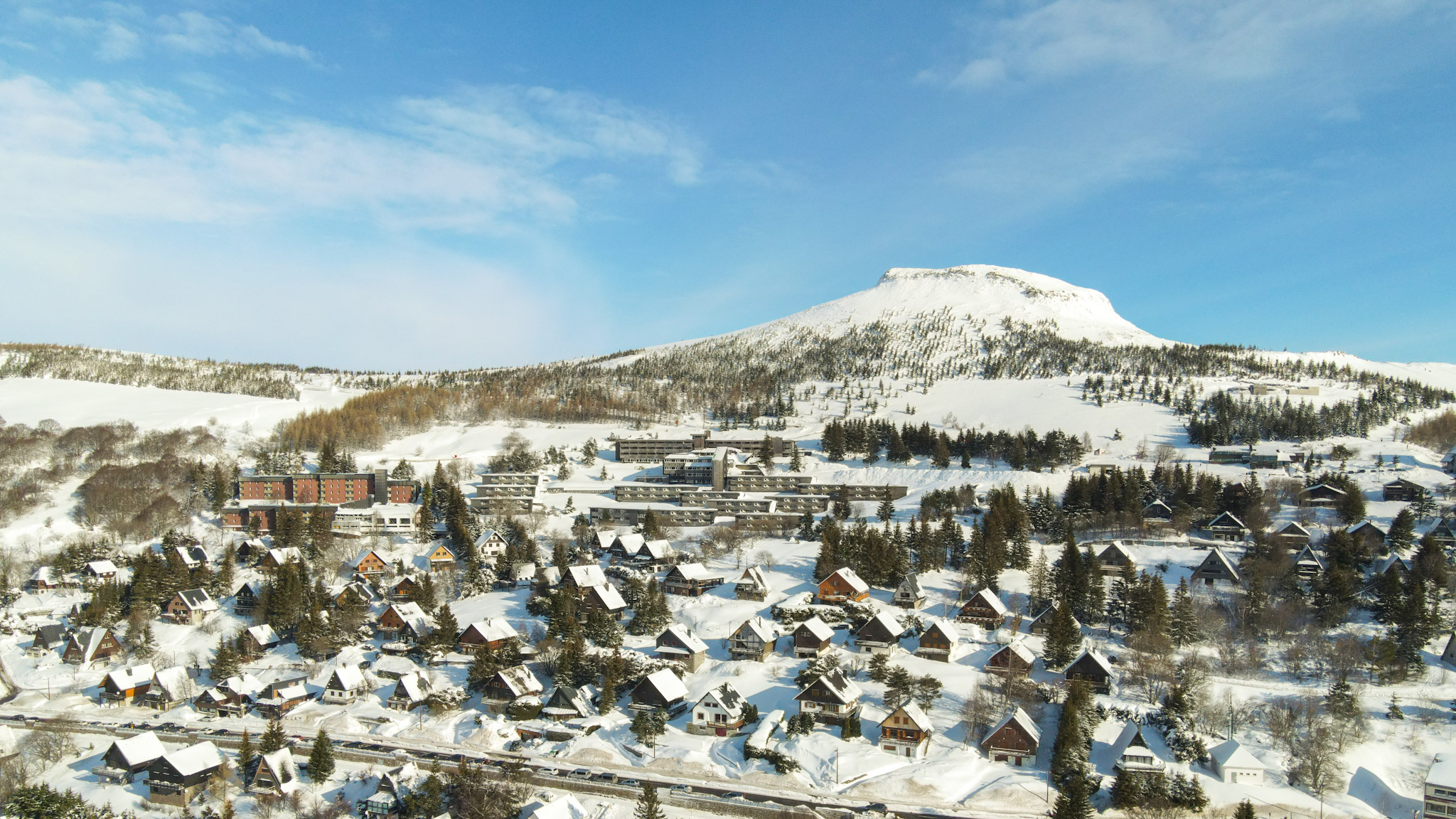 Super Besse seen from the Sky: Village of Chalets nestled on the slopes of Puy du Chambourguet