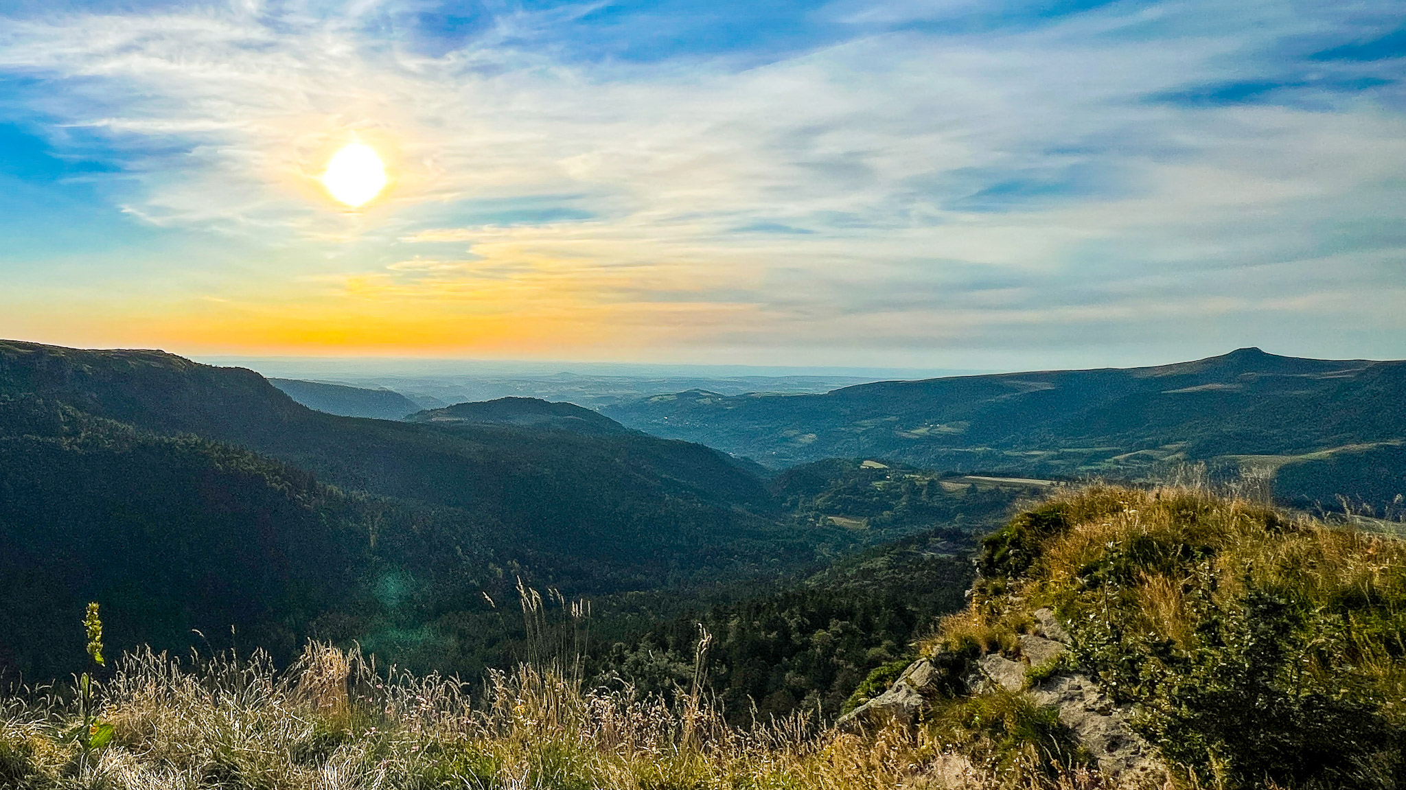 Flaming sunset over the Banne d'Ordanche from the summit of Capucin at Mont Dore.