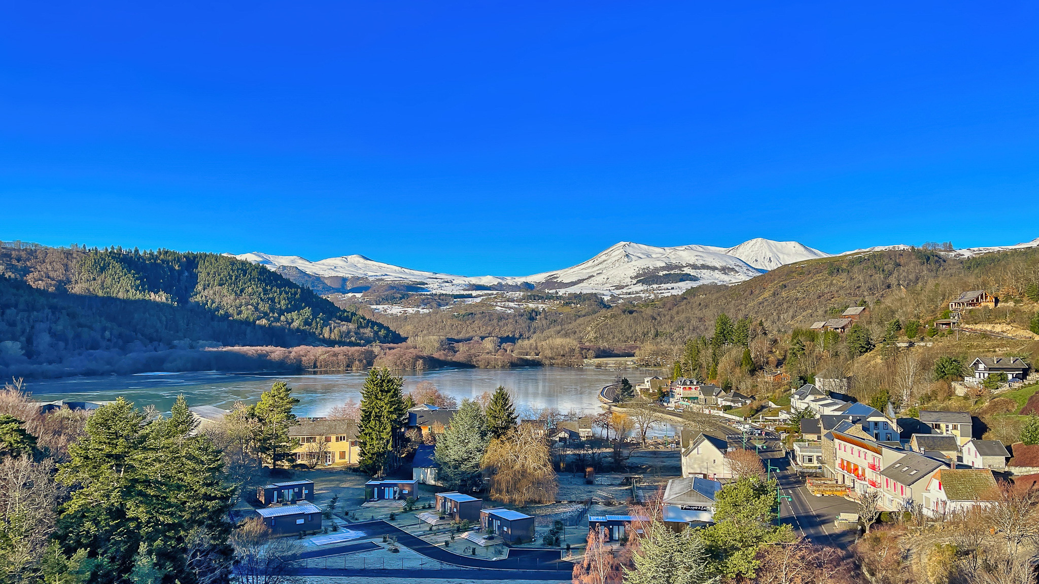 Lake Chambon: An enchanting landscape, the snow-covered Sancy Massif in the background.